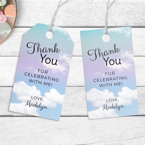 May include: Two blue and purple thank you tags with a cloudy sky background. The text on the tags reads "Thank You" for celebrating with me! Love, Madelyn.