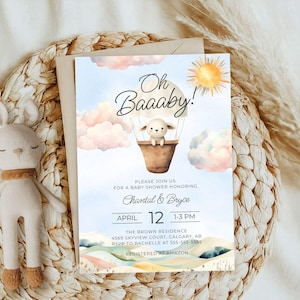 May include: A baby shower invitation with a watercolor illustration of a lamb in a hot air balloon. The invitation is blue with white clouds and a yellow sun. The text reads "Oh Baaaby!" and includes the date, time, and location of the shower.