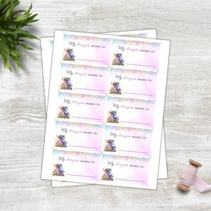 May include: Ten printable name tags featuring a cute cartoon dragon with rainbow wings and a pink background. The text on each tag reads "My dragon name is".