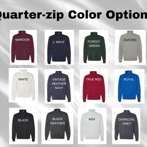 May include: Image showcasing a variety of quarter-zip sweatshirts in different colors. The options include maroon, navy, forest green, oxford gray, white, vintage heather navy, true red, royal blue, black, black heather, ash, and charcoal grey. Each sweatshirt has a high collar.