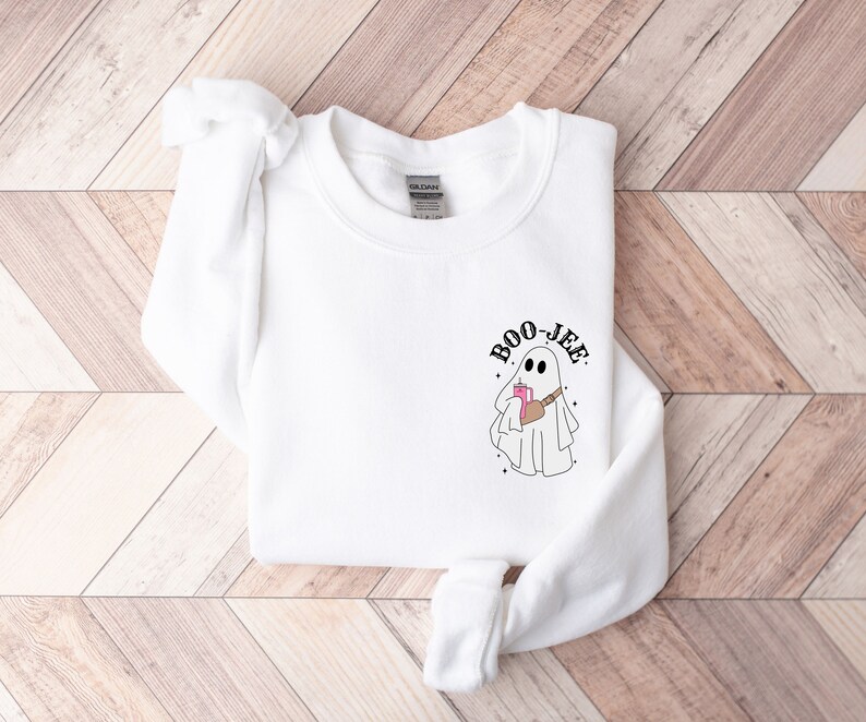 May include: White sweatshirt with a ghost graphic and the text 'BOO-JEE'.