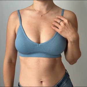 May include: A light blue ribbed bralette with a V-neckline.