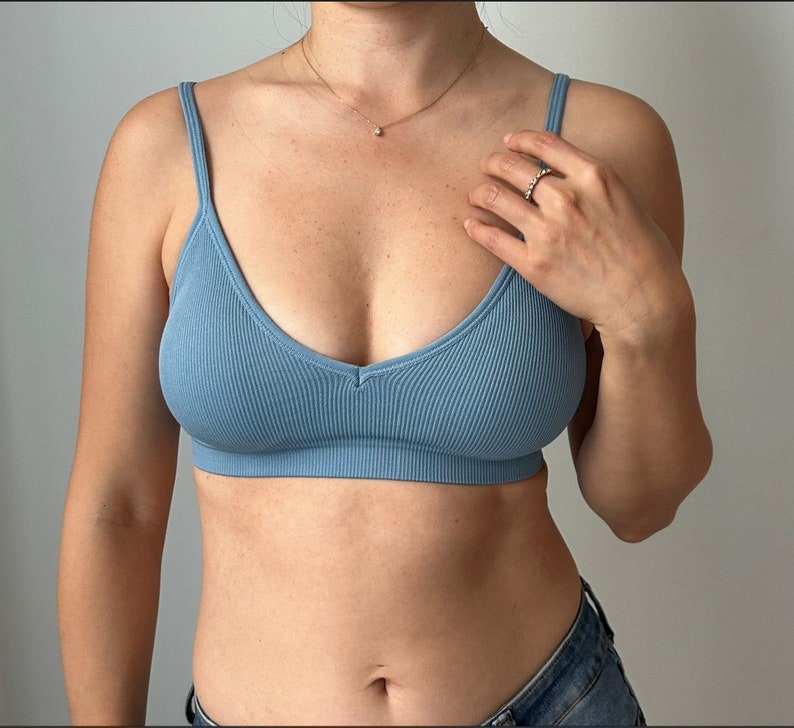 May include: A light blue ribbed bralette with a V-neckline.