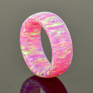 May include: A pink and white opal ring with a smooth, polished finish.