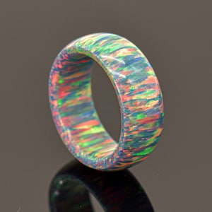 May include: A colorful ring with a swirling pattern of blue, green, pink, and orange.