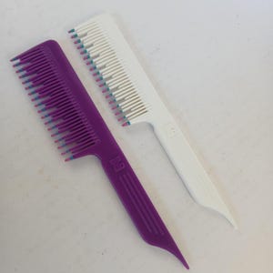 May include: A set of three ceramic mugs with a speckled, matte finish. The mugs are in shades of cream, light gray, and dark gray. Each mug has a simple, minimalist design and a rounded handle.