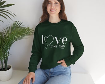 Unisex Heavy Blend™ Crewneck Sweatshirt" love never fails" big logo