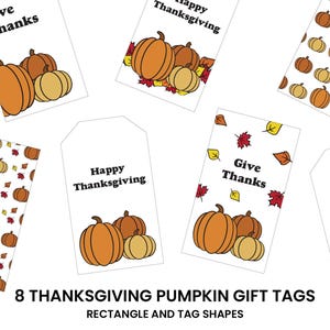 以下が含まれることがあります： 長方形とタグの形をした、感謝祭をテーマにしたギフトタグ。オレンジと黄色のカボチャのイラストが描かれており、「Give Thanks」と「Happy Thanksgiving」のフレーズが書かれています。