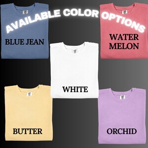 May include: Five t-shirts in different colors: blue jean, white, butter, water melon, and orchid. The text "AVAILABLE COLOR OPTIONS" is at the top of the image.