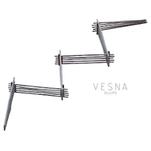 May include: Abstract sculpture with a zigzag design. The sculpture is constructed from light grey supports and horizontal wooden rods. The text "VESNA SCULPTS" is displayed in a minimalist font.