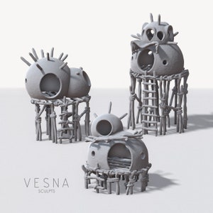 May include: Three gray ceramic birdhouses with a rustic, primitive style. Each birdhouse is perched on a platform made of sticks and rope. The birdhouses have round, dome-shaped roofs with holes for entry.