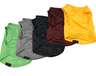 May include: Five sleeveless dog shirts in different colors: green, gray, black, maroon, and yellow. The shirts are made of a soft, breathable material and have a comfortable fit.