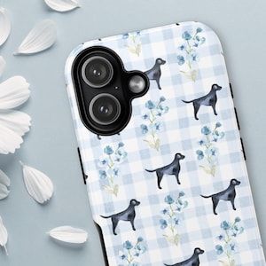 May include: A white and blue gingham patterned phone case featuring black dog silhouettes and blue floral accents. The case has a camera cutout and black side accents. The design is repeated across the entire surface of the phone case.