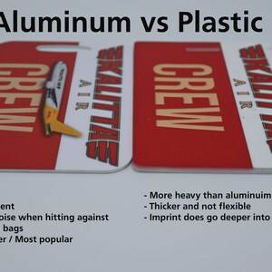 May include: Two luggage tags, one made of aluminum and one made of plastic, both red with white lettering. The aluminum tag is lighter and can be bent, while the plastic tag is thicker and more durable. Both tags feature the text "CREW" and "SKALITTAE AIR".