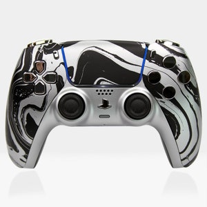 May include: A silver and black PlayStation 5 DualSense wireless controller with a marbled design. The controller has a black and white swirl pattern.