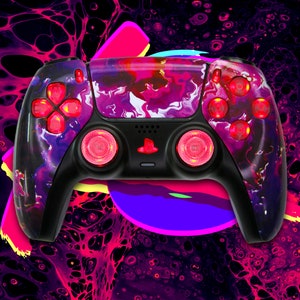 May include: A black and purple video game controller with a marbled design. The controller has red buttons and pink accents.