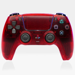 May include: A red translucent PlayStation 5 DualSense wireless controller with black buttons and a PlayStation logo. The controller has a textured grip and a transparent design.