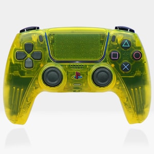 May include: A bright yellow translucent PlayStation 5 DualSense wireless controller. The controller has a textured grip and a black PlayStation logo on the front.