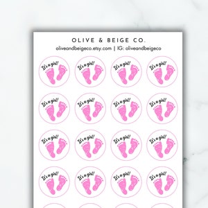 May include: Twenty-four pink and white round stickers with the text "It's a girl!" and a pink footprint design.