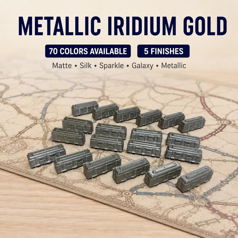 May include: A collection of small, metallic iridium gold train car game pieces. The text reads: METALLIC IRIDIUM GOLD, 70 COLORS AVAILABLE, 5 FINISHES, Matte, Silk, Sparkle, Galaxy, Metallic. These rectangular pieces feature molded details.