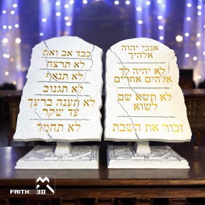 May include: Two white stone tablets with gold lettering, depicting the Ten Commandments in Hebrew. The tablets are on a white base with intricate carvings.