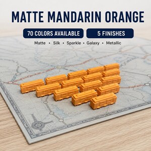 May include: A collection of small, rectangular, matte mandarin orange train car game pieces arranged on a board game map. Text on the image reads: MATTE MANDARIN ORANGE, 70 COLORS AVAILABLE, 5 FINISHES, Matte, Silk, Sparkle, Galaxy, Metallic.