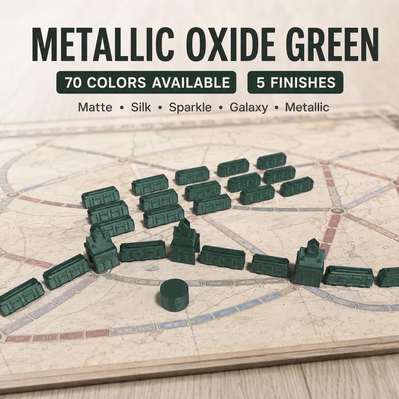 May include: A collection of dark green plastic train cars and station pieces arranged on a board game map. Text at the top reads METALLIC OXIDE GREEN, 70 COLORS AVAILABLE, 5 FINISHES, Matte, Silk, Sparkle, Galaxy, Metallic.