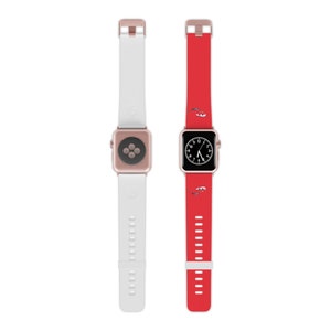 以下が含まれることがあります： 2本のApple Watchバンド、1つは白、もう1つは赤、ローズゴールドの文字盤。赤いバンドには小さな赤い魚の模様があります。