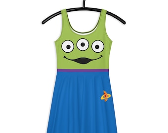 May include: A green and blue dress with a cartoon alien face on the bodice and a small alien spaceship on the skirt.