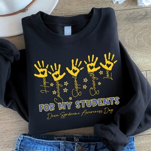 May include: Black sweatshirt with yellow handprints and the words "Hope, Courage, Support, Strength, Love" and "For My Students Down Syndrome Awareness Day".