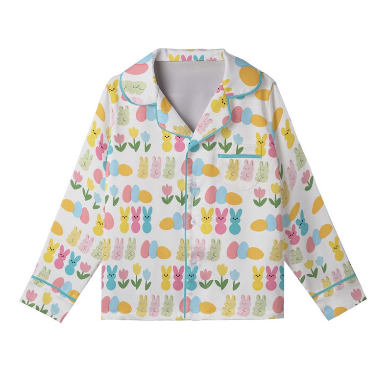 May include: White pajama top with a colorful Easter-themed pattern. The design includes cartoon bunnies, Easter eggs, and tulips in shades of yellow, pink, blue, and green. The pajama top has a button-down front, a collar, and light blue trim.