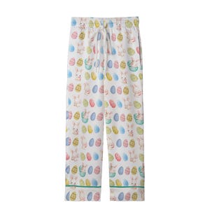 May include: White pajama trousers with an Easter-themed pattern. The trousers feature a repeating design of pastel-coloured Easter eggs and bunnies. They have a drawstring waist and a green trim along the bottom.