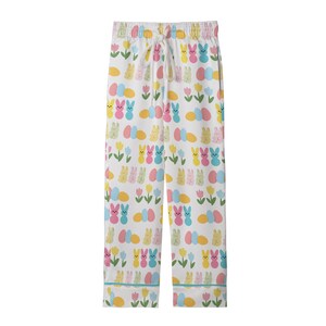 May include: White pajama pants with an Easter-themed pattern. The design includes colorful Easter eggs, bunnies, and tulips. The pants have a drawstring waist and are trimmed with a light blue piping.