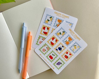 May include: Two sticker sheets with a variety of fruit designs. The sticker sheets are labeled "Fruity Stamps" and feature images of lemons, oranges, watermelons, cherries, grapes, peaches, and blueberries. The sticker sheets are on a white background.