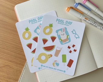 May include: Two sticker sheets with a pool day theme. The sheets feature a variety of summer-themed stickers, including a pineapple, watermelon slices, a rubber ring, a beach ball, an ice cream cone, a glass of juice, a pair of sunglasses, and a bunny rabbit wearing a swimsuit. The text on the sheets reads "Pool Day Sticker Sheet" and "On My Days Off Studio".