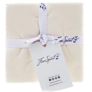 Puede incluir: Un conjunto de cuadrados de tela color crema atados con una cinta blanca con el texto "Free Spirit" y un logotipo. Una etiqueta blanca con el logotipo "Free Spirit" y los iconos de las redes sociales cuelga de la cinta.