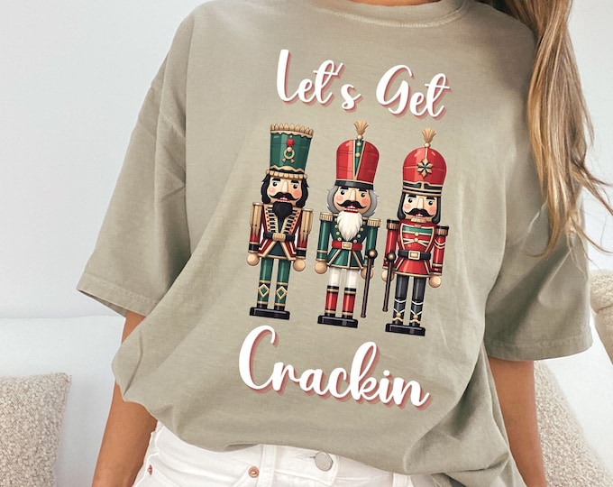 Featured listing image: Nutcracker Tee: Dive into Fun "Lets Get Crackin" with Vibrant Graphic Style