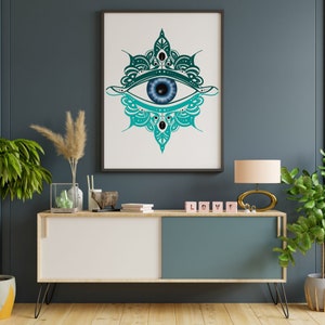 May include: A framed print of a teal blue and green evil eye design with a blue eye in the center. The print is hanging on a dark blue wall above a white and teal blue cabinet with a wooden top. The cabinet has a wooden top and metal legs. There are decorative items on the top of the cabinet, including a wooden animal figurine, a glass vase, and a stack of books. There are also four pink blocks spelling out the word "LOVE" on the cabinet.