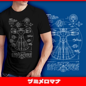Op de afbeelding: Een zwart T-shirt met een witte afbeelding van een robotontwerp. Het ontwerp bevat de tekst "UFO Robot Grendizer" en Japanse tekst.