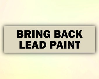 May include: A white rectangular sign with black text that reads "BRING BACK LEAD PAINT".