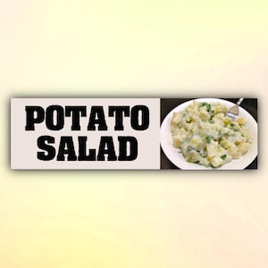 May include: A white bowl containing potato salad. The salad is made with potatoes, mayonnaise, and spring onions. The bowl is on a white background. The text "POTATO SALAD" is written in black letters on a white background.