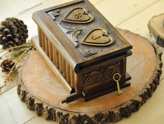 A personalized hand-carved heart-shaped wooden puzzle box with a secret lock — 147 favorites on a $110 item is a strong signal this is genuinely special and giftable.