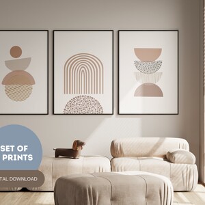 May include: A set of three framed art prints with abstract geometric designs in neutral tones. The prints feature shapes like arches, half-circles, and stacked forms. The text "SET OF 3 PRINTS" and "DIGITAL DOWNLOAD" are also visible.