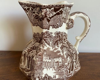 A Mason's Ironstone brown 'Vista' Ware jug, after 1940, made in England, castle pattern and elaborate dragon-inspired handle.