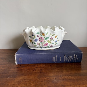 May include: A set of three ceramic mugs with a speckled, matte finish in cream, light grey, and dark grey. Each mug has a simple, minimalist design, suitable for coffee or tea.