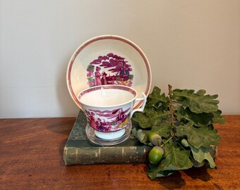 Lustre ware antique cup and saucer - depicting sailor and his lass watching a boat sailing towards them.  Good Comdition