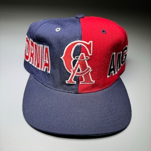 May include: A blue and red baseball cap with the words "CALIFORNIA" and "ANGELS" on the sides and a white "A" logo in the centre.