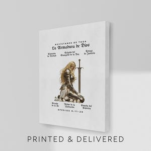 May include: A white canvas print featuring a kneeling figure in armor with a sword, and text in Spanish. The text includes "La Armadura de Dios" and "PRINTED & DELIVERED". The artwork has a religious theme.