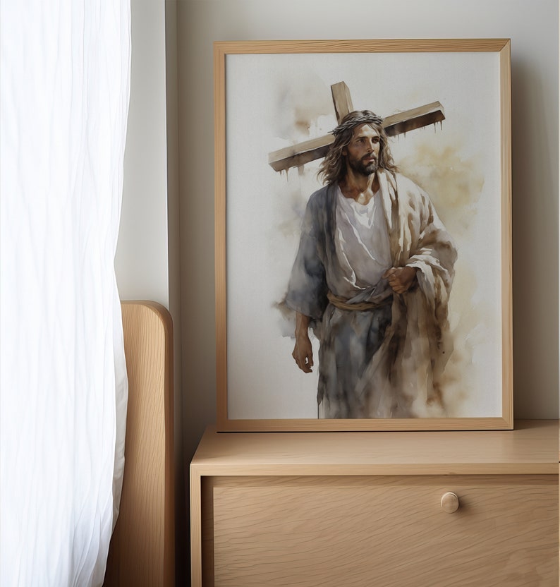 May include: A framed watercolour painting of a man carrying a wooden cross on his shoulders. The man is wearing a long robe and has a crown of thorns on his head. The painting is set against a light brown background.