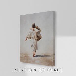 May include: A canvas print depicting a person in white robes carrying another person. The artwork is rendered in soft, muted tones, with a focus on the figures and their interaction. The text "PRINTED & DELIVERED" is printed at the bottom of the canvas.